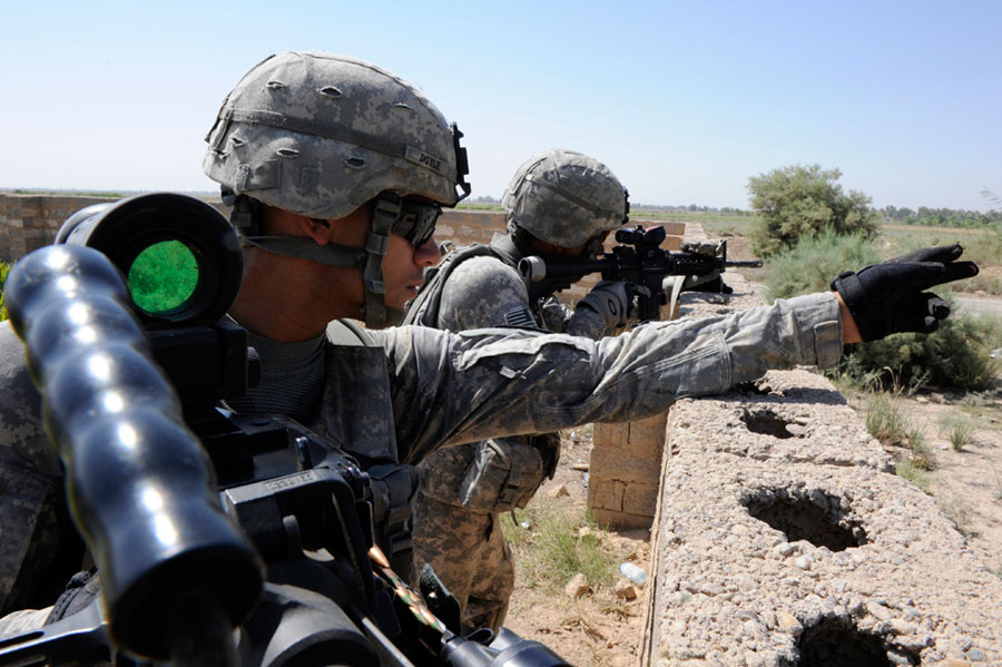 Soldiers provide security while their platoon attends local council meeting