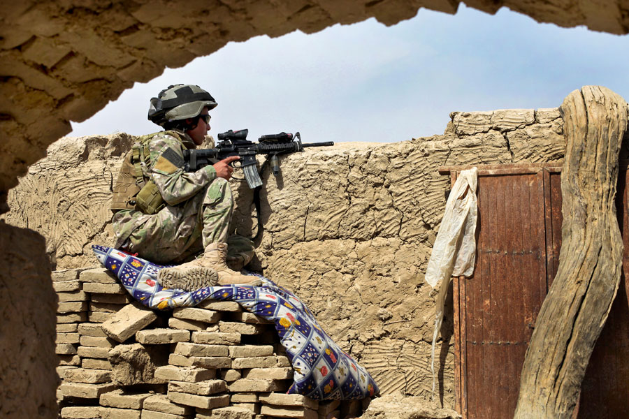 Afghan-international security force secures area with M-4 rifle