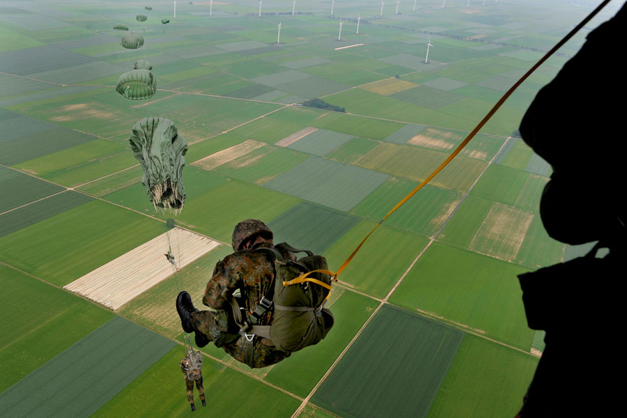 Soldiers parachute from C-130J Hercules aircraft