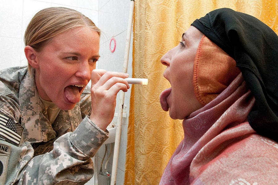 Female Medic provides health exam Iraq woman