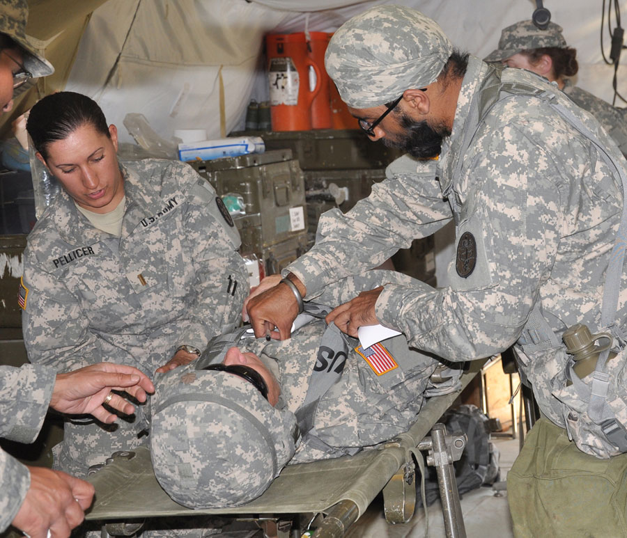 Sikh Soldier doctor checks patient during triage portion of Basic Officer Leadership Course