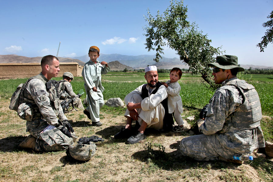 Interpreter speaks with an Afghan man in village of IbrahimKhel, Nerkh District, Wardak Province, Afghanistan
