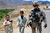 An Afghan youth attempts to sell a tame bird to Soldier