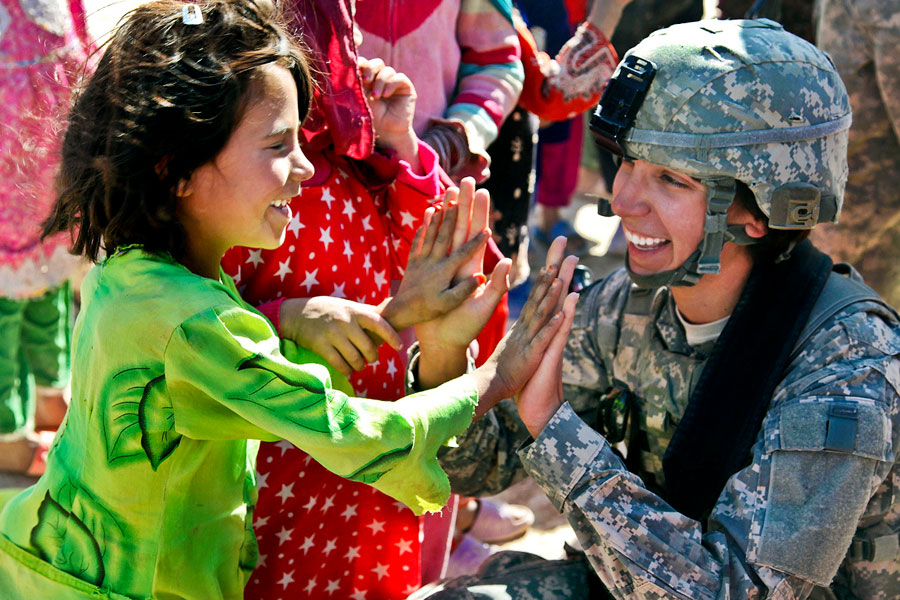 86th Infantry Brigade Combat Team Soldier interacts with an Afghan child