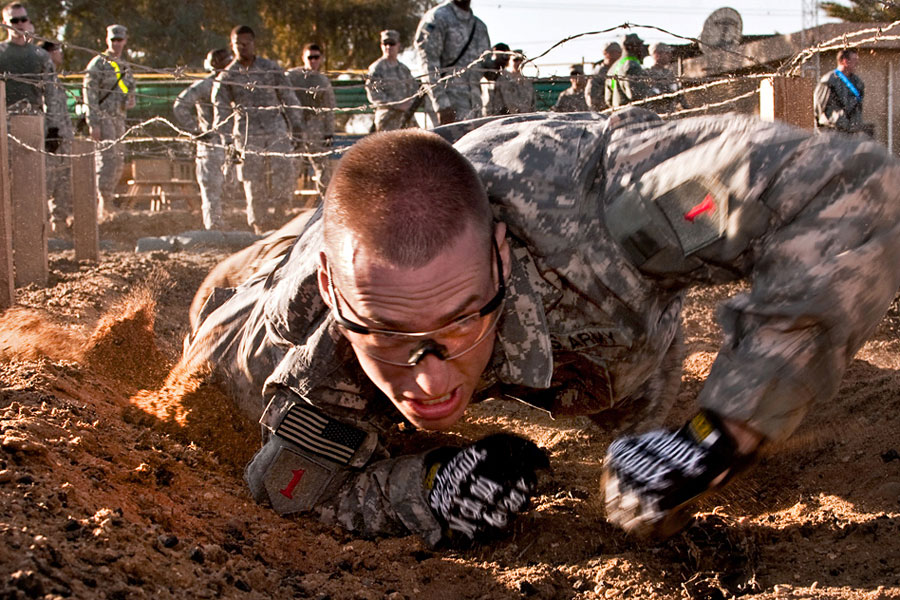 Soldier crawls under a barbed wire obstacle during Demon Fury
