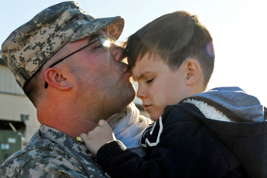 Soldier kisses son