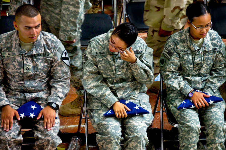 Soldier wipes tear from her eye after becoming United States citizen during Veterans Day Naturalization Ceremony