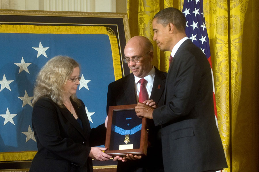 President Barack Obama presents the Medal of Honor posthumously to the parents of Staff Sergeant Robert J. Miller