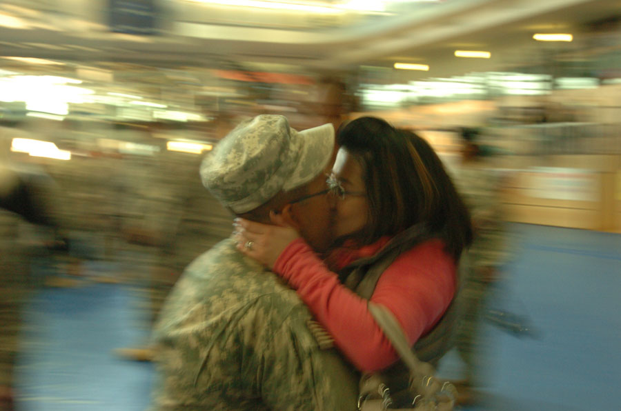 Soldier kisses his wife