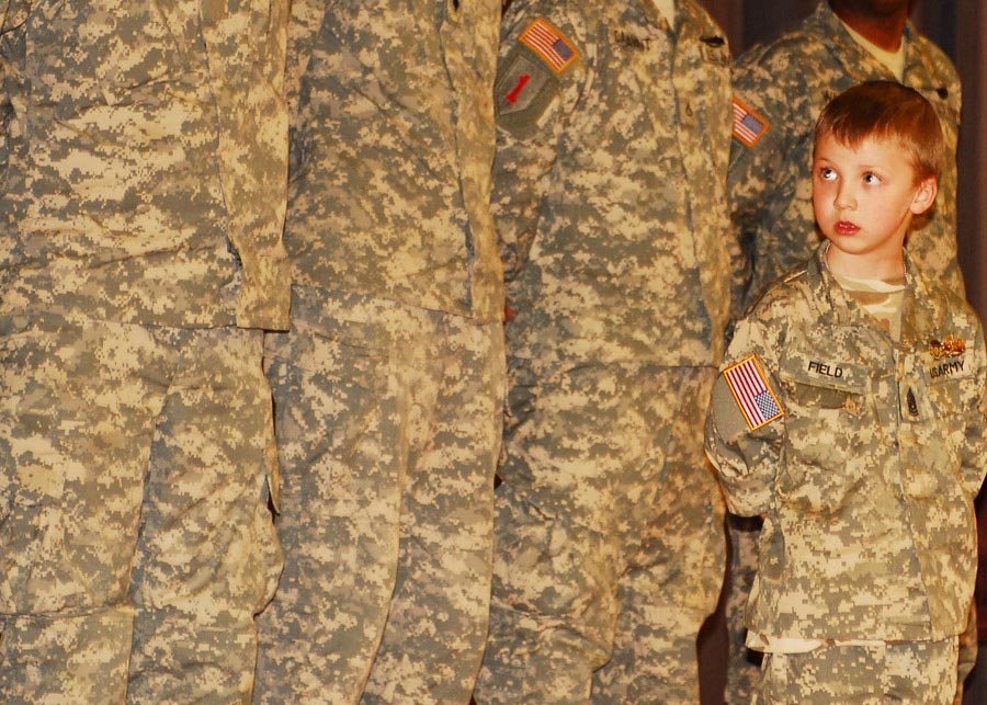Command Sergeant Major Ian Field, 7, stands with his squad during a farewell award ceremony at Barlow Theater on Fort Riley, Kansas