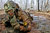 Crawling through mud, Private Charles Shidler searches for the next covered fighting position during individual movement techniques training