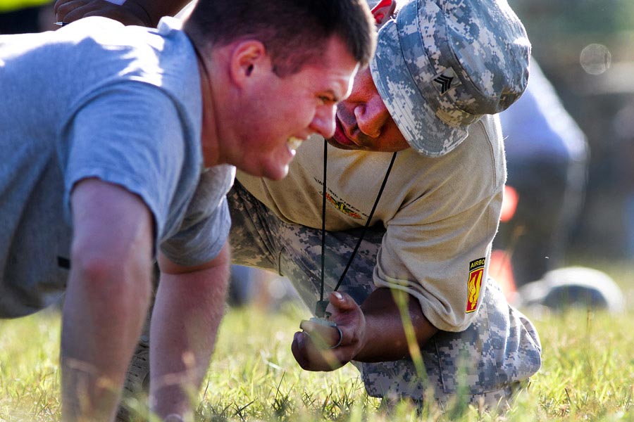 A grader for the new Army Physical Readiness Test ensures that a paratrooper completes the new 60-second pushup event correctly