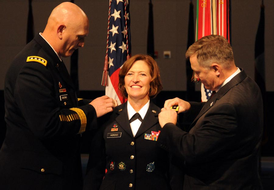 Chief of Staff of the Army General Raymond T. Odierno and retired Colonel Ray Horoho pin three-star epaulets on the shoulders of Lieutenant General Patricia D. Horoho