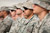 Service members watch as the U.S. Forces-Iraq flag is cased