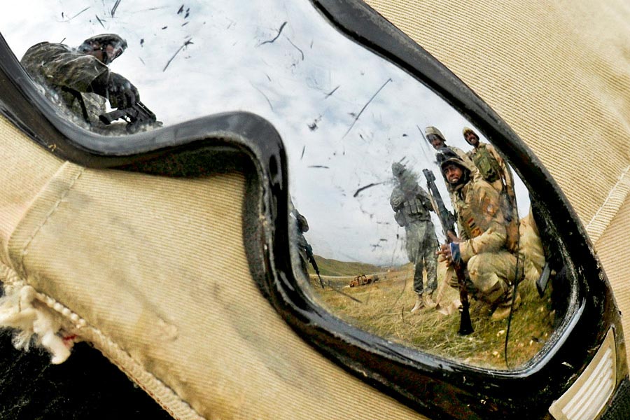 Reflection of Army Staff Sergeant Kevin Murphy in goggles instructing Iraqi soldiers