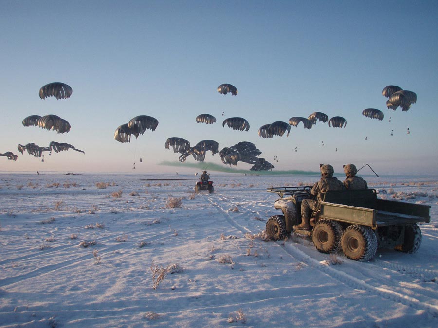 Soldiers waiting as fuel is dropped by C-17