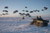 Soldiers waiting as fuel is dropped by C-17
