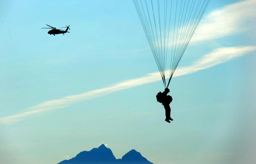Paratroopers of the 1st Battalion (Airborne), 501st Infantry Regiment, conduct a parachute training and water landing exercise at Big Lake, Alaska