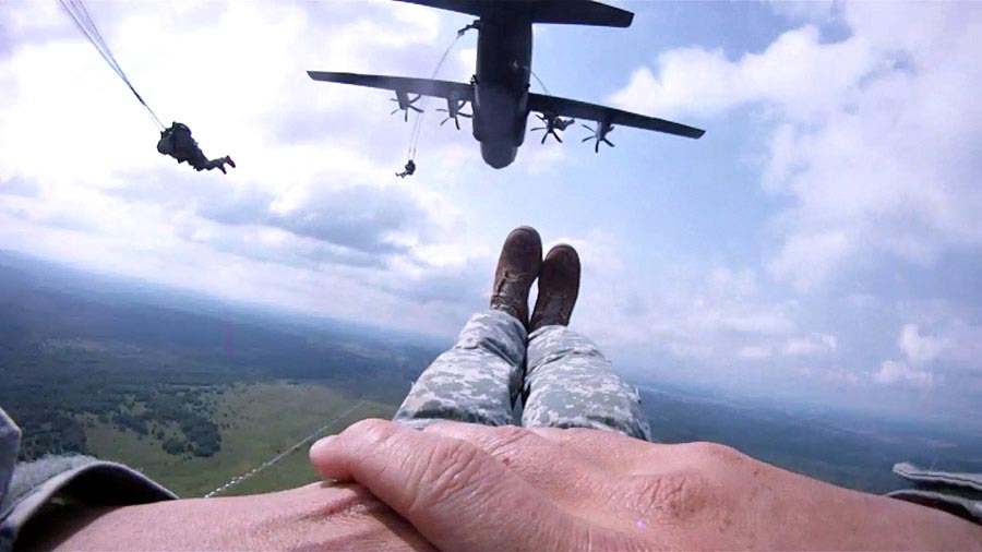Staff Sergeant Travis Surber parachutes out of a C-130 Hercules Transport Aircraft