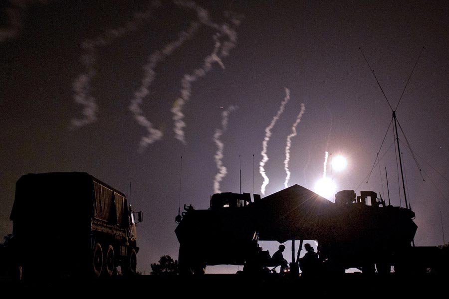 A combat observation lasing team calls in illumination rounds from nearby mortars during training at Fort Bragg, North Carolina