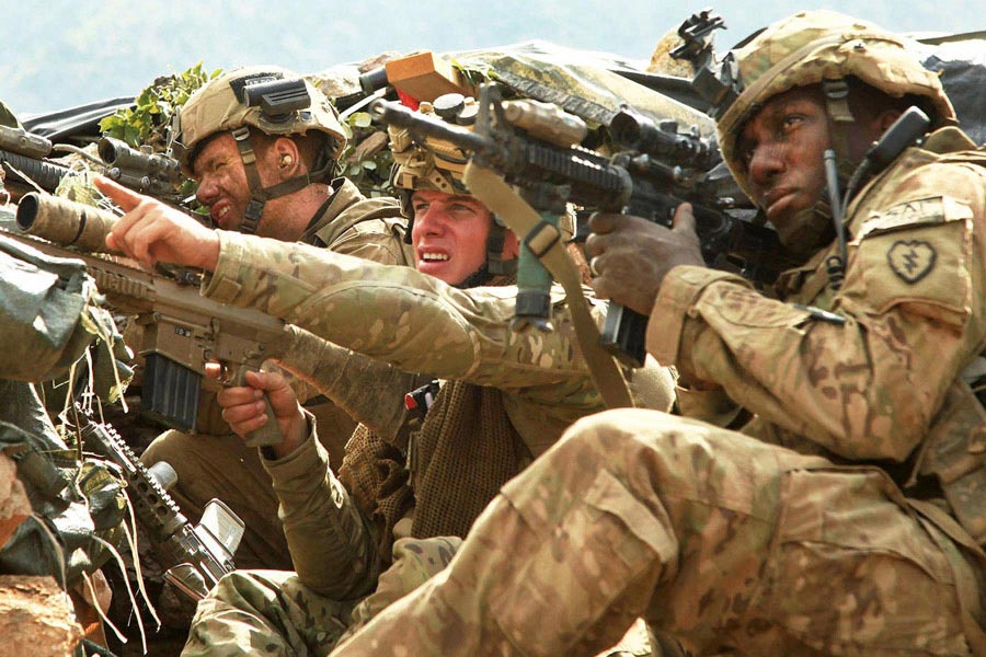 Soldiers survey the ridgeline after taking in sniper fire from an insurgent during Operation Diamond Head in Afghanistan