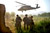 Afghan commandos with the Afghan National Army’s 3rd Commando Kandak shield their faces from flying debris after loading a wounded commando on a U.S. Army UH-60 Black Hawk helicopter