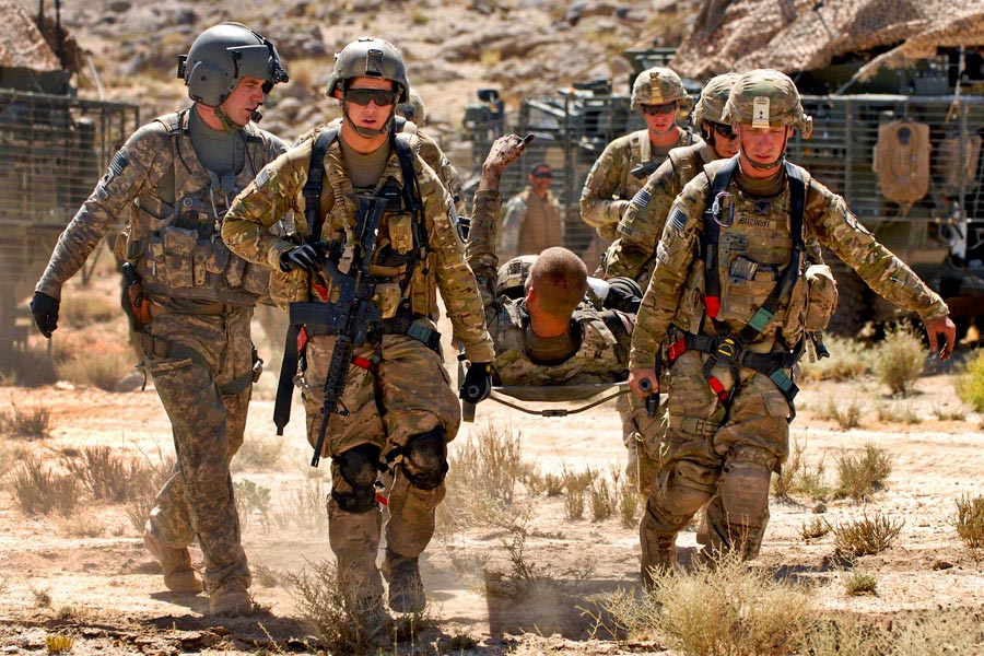 Private First Class Shawn Williams gives the thumbs-up to members of his unit as he is evacuated after being injured by a roadside bomb