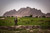 A Soldier walks through a valley during a patrol through Malajat, Afghanistan