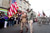 Zane Schlemmer, a veteran United States Army paratrooper who jumped into northern France as a sergeant with the 82nd Airborne Division, walks in his jump boots down the main street of Sainte-Mère-Église, France, with other World War II veterans during the 67th anniversary of the Allied invasion of France