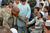 Captain Derrick W. Dew plays with young residents of Kandahar City during a ribbon cutting ceremony for a new soccer field