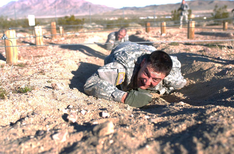 First Lieutenant Michael Keyser crawls through an obstacle during Pre-Ranger Assessment Course
