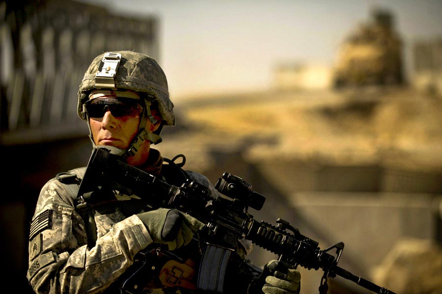 Sergeant Carl Goss secures an area near a bridge construction site in Zabul province, Afghanistan