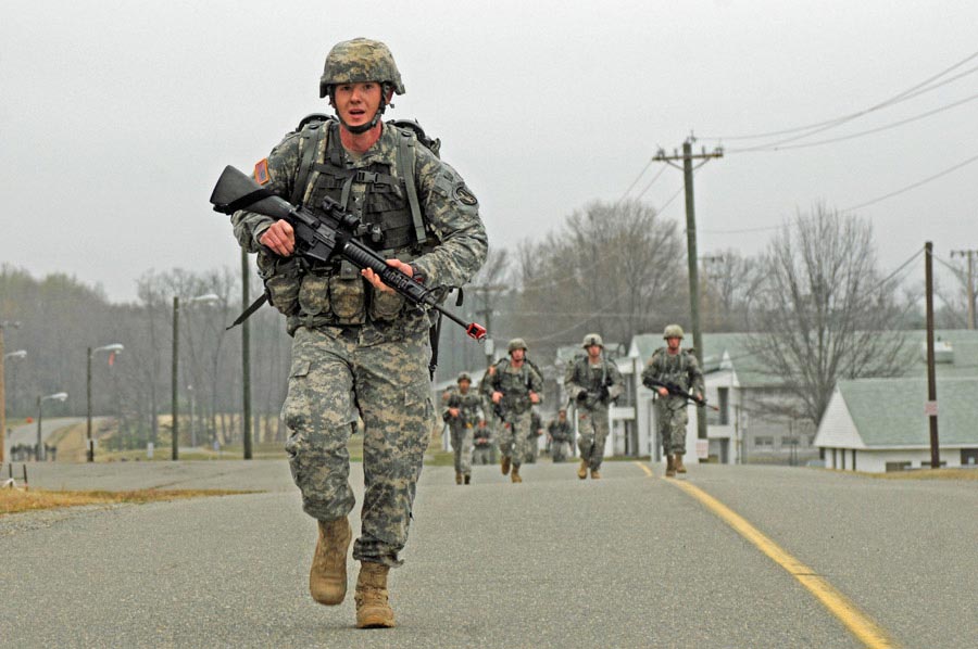 Soldiers prepare to cross the finish line after 12-mile road march during The Old Guard’s Expert Infantryman Badge testing at Fort A.P. Hill, Virginia