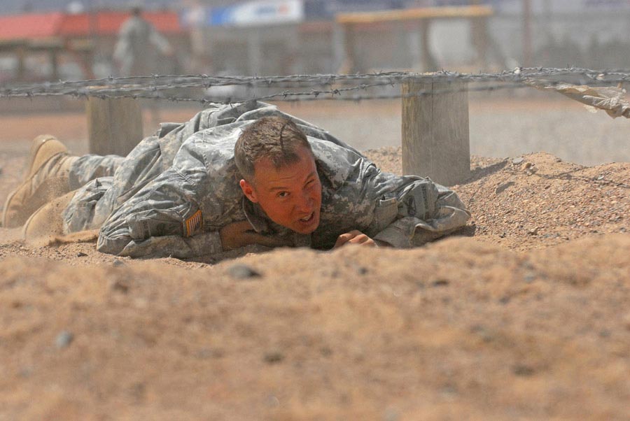 A Soldier completes the low-crawl obstacle on the Fort Bliss obstacle course