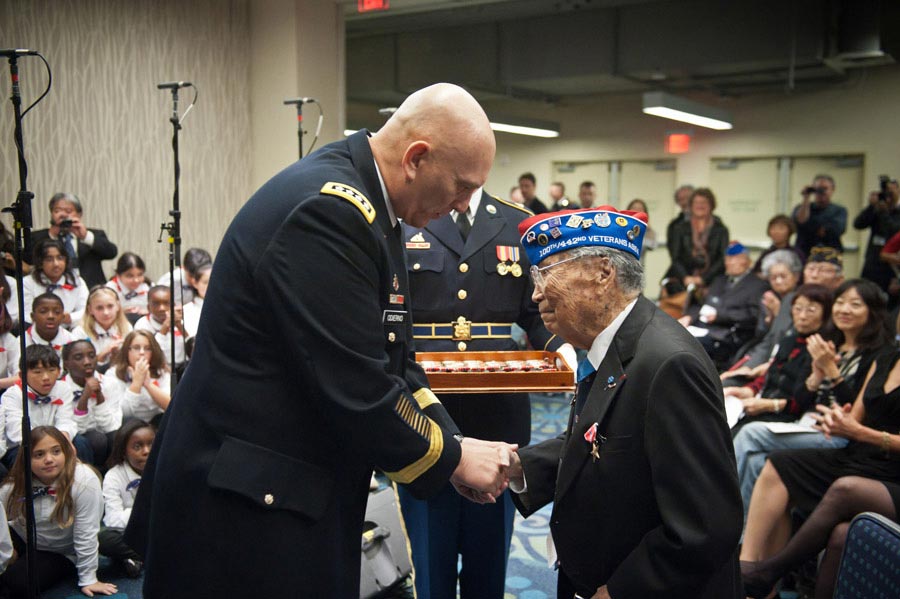 United States Army Chief of Staff General Raymond T. Odierno presents a Bronze Star Medal and the Army Chief of Staff coin to George Joe Sakato at the World War II Nisei Veterans Program National Veterans Network tribute