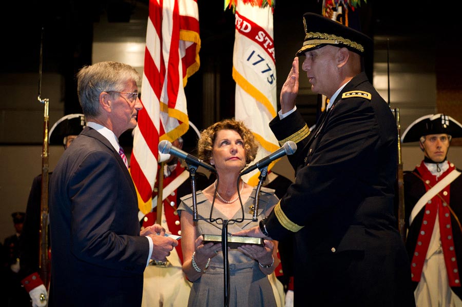 Secretary of the Army John McHugh administers the oath to Genneral Raymond T. Odierno during a change of responsibility ceremony as Odierno's wife Linda looks on