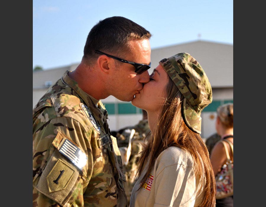 Chief Warrant Officer 2 Bryan Crumpler with the 82nd Combat Aviation Brigade shares a last kiss with his wife