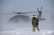 A Soldier oversees the liftoff of a UH-60 Black Hawk flown during medical evacuation training in harsh weather conditions