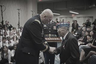 United States Army Chief of Staff General Raymond T. Odierno presents a Bronze Star Medal and the Army Chief of Staff coin to George Joe Sakato at the World War II Nisei Veterans Program National Veterans Network tribute
