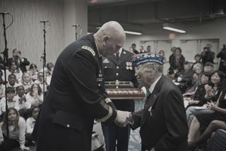 United States Army Chief of Staff General Raymond T. Odierno presents a Bronze Star Medal and the Army Chief of Staff coin to George Joe Sakato at the World War II Nisei Veterans Program National Veterans Network tribute