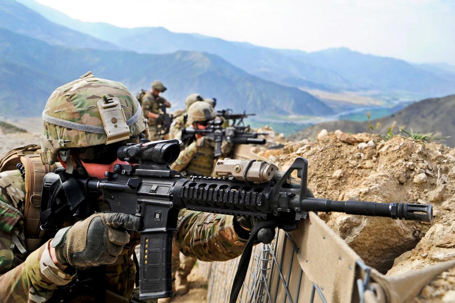 Army National Guard Specialist Timothy Shout, scans nearby ridgeline along with other members of Provincial Reconstruction Team Kunar Security Force