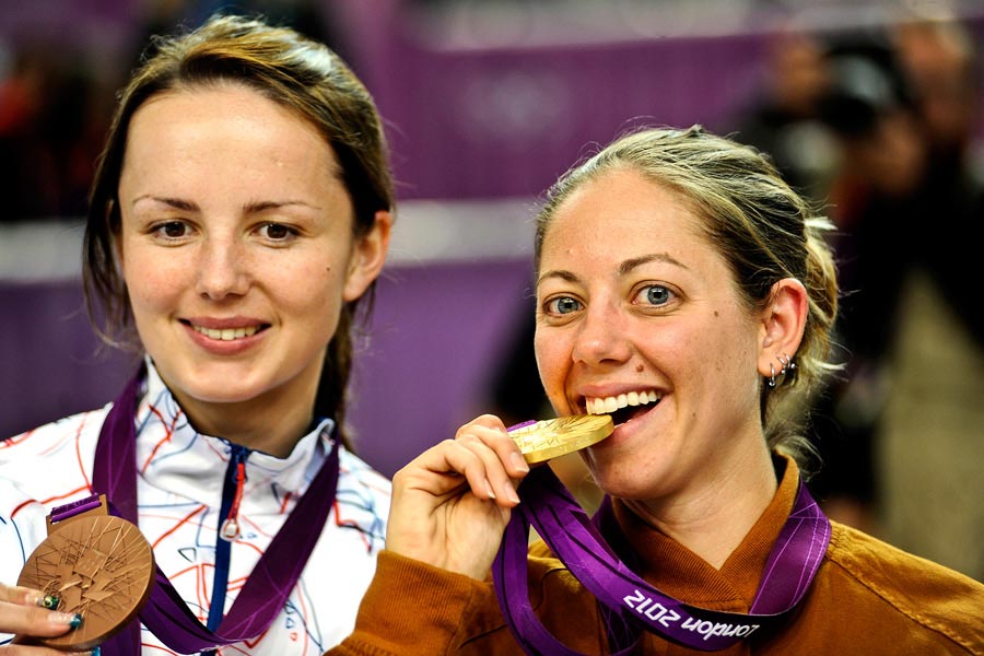 Jamie Gray bites her Olympic gold medal after winning the women's 50-meter rifle 3-positions event