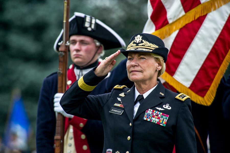 General Ann E. Dunwoody salutes during playing of national anthem at her retirement ceremony