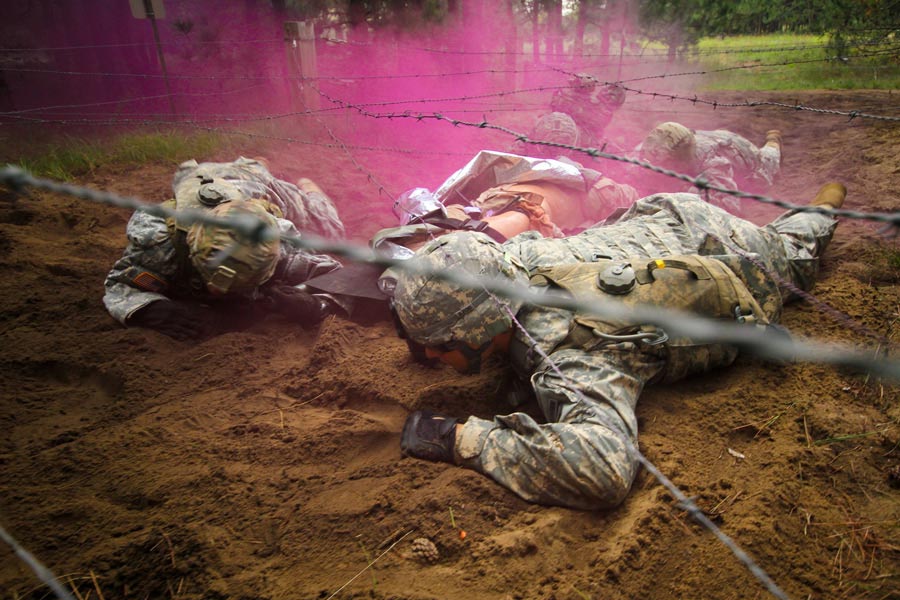 Team of medics from 89th Cavalry Regiment, negotiate wire obstacle during best medic competition