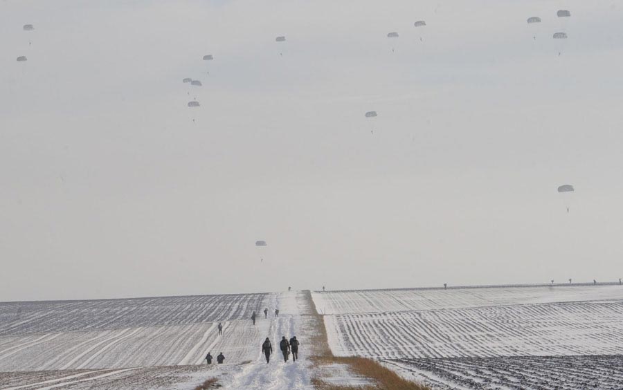 Paratroopers walk to meeting point as fellow Soldiers, Airmen and partner nation jumpers make their final decent