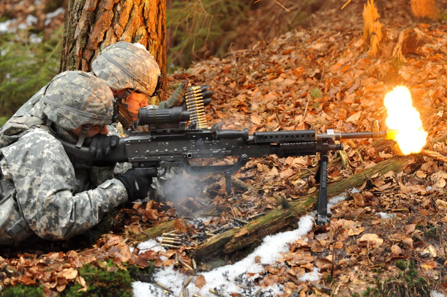Private Alex Hernandez (front) and Specialist Justin Huser, both from Ghost Company, fire their M240 machine gun
