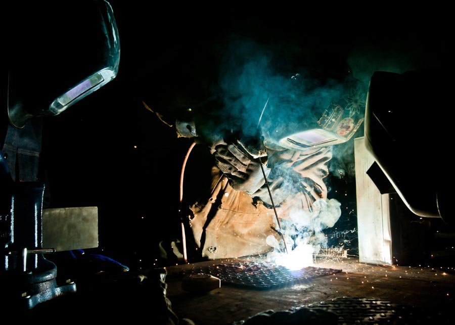 Specialist Brady Myatt, 172nd Infantry Brigade, demonstrates basic welding techniques for his partnered trainees