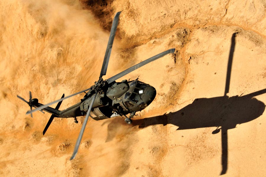Members of UH-60 Black Hawk helicopter crew, assigned to 25th Combat Aviation Brigade, come in for dust landing