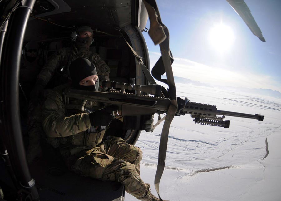 Corporal William Hopkins, of 82nd Combat Aviation Brigade's Pathfinders, looks through scope of Barrett .50 caliber sniper rifle