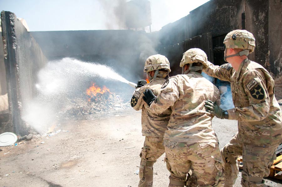 Corporal William Lamm, 2nd Infantry Division, directs Soldiers during an incipient fire exercise